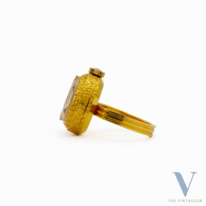 SEIKO RING WATCH REF. 17-0610, BLUE-PURPLE DIAL, FACETED DIAMOND-SHAPED CRYSTAL, 18KT YELLOW GOLD CASE, IN-HOUSE MANUAL WINDING MOVEMENT, FROM THE 1970s