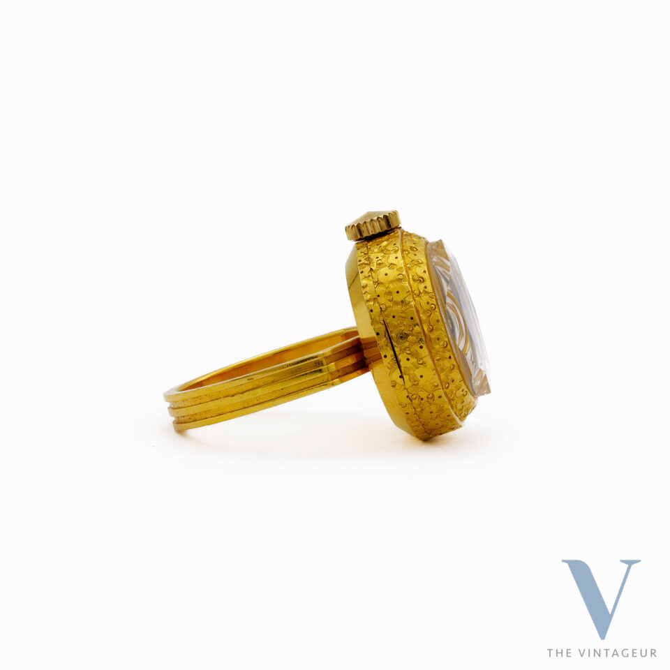 SEIKO RING WATCH REF. 17-0610, BLUE-PURPLE DIAL, FACETED DIAMOND-SHAPED CRYSTAL, 18KT YELLOW GOLD CASE, IN-HOUSE MANUAL WINDING MOVEMENT, FROM THE 1970s