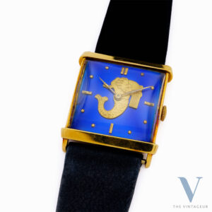UNIVERSAL GENEVE "TRITON" REF. 10912, BLUE ENAMEL DIAL WITH EMBOSSED GOLD MINIATURE OF TRITON, SQUARE-SHAPED 18KT YELLOW GOLD CASE, HAND-WOUND UG 264 MOVEMENT, FROM THE 1940s