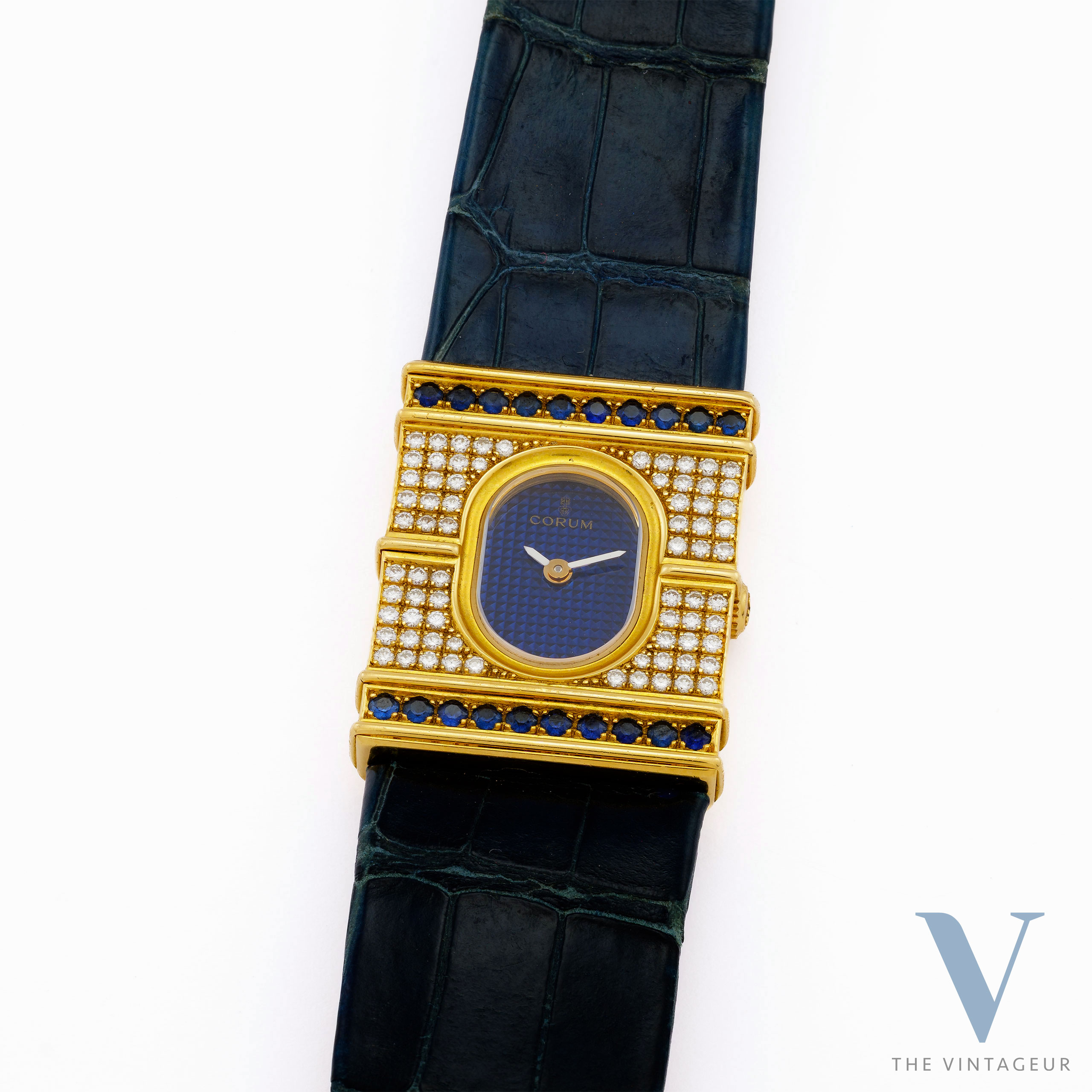 CORUM "ARC DE TRIOMPHE" REF. 24.374.65, BLUE GUILLOCHE DIAL, 18KT YELLOW GOLD CASE WITH DIAMONDS AND SAPPHIRES, ISA 125 QUARTZ MOVEMENT, FROM 1980 CORUM "ARC DE TRIOMPHE" REF. 24.374.65, BLUE GUILLOCHE DIAL, 18KT YELLOW GOLD CASE WITH DIAMONDS AND SAPPHIRES, ISA 125 QUARTZ MOVEMENT, FROM 1980